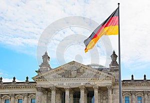 Waving German flag over the Reichstag building in Berlin