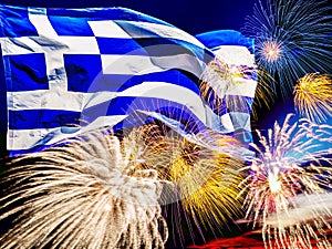 Waving greek flag against sunset sky with colorful exploding fireworks. Celebration day concept. Greece flag with salute