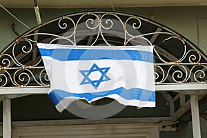Waving Israeli flag old building, Tel Aviv