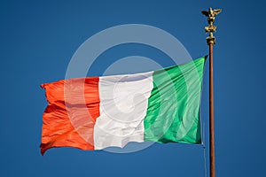 Waving Italian flag against blue sky  Rome  Italy
