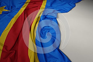 waving national flag of democratic republic of the congo on a gray background