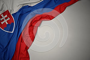 Waving national flag of slovakia on a gray background