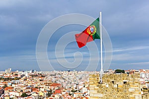 Waving portuguese flag on top of Saint Jorge Castle in Lisbon