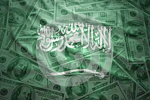 waving saudi arabia flag on a american dollar money background