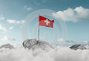 Waving Swiss flag above sea of clouds to celebrate the national holiday of 1 august