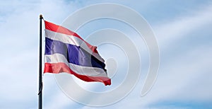 Waving Thailand flag with blue sky background .  Symbol of Thailand in Southeast Asia .