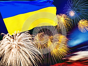 Waving Ukraine flag against sunset sky with colorful exploding fireworks. Celebration independence day concept. Ukraine flag with