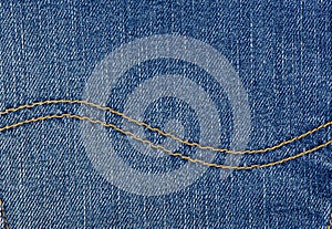 Wavy double seam on jeans. Denim fabric as background