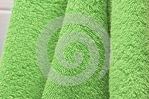 Dry bath towels are green in the bathroom