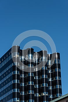 Wavy formed glass facade of a newly constructed office skyrise.. photo