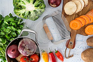 wavy knife for vegetables. Carrot slices and potatoes on a cutting board. Saucepan, Onions, broccoli, tomatoes and parsley top