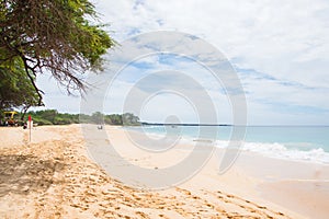 Wavy ocean hitting the sandy beach in Oahu Island, Hawaii