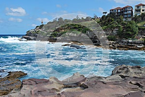 Wavy ocean and rocky coastline near famous Sydney Bondi Beach