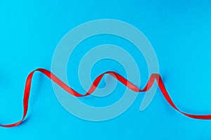 Wavy red ribbon on a blue background.