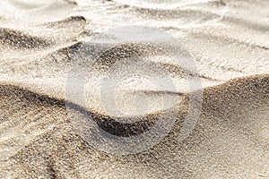 The wavy sandy surface of the dune. Rest and relaxation at a resort by the sea. Close-up. Background. Space for text