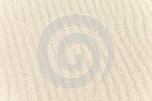 The wavy texture of the sand on the beach. The background image. Top view