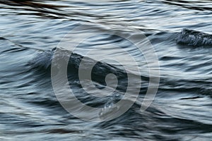 Wavy turbulent water with silky surface in long exposure and motion blur effect