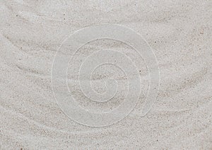 Wavy white sand, top view. Sandy beach background. Abstract sand texture close up. Summer concept.