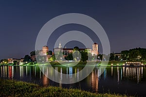 Wawel Royal Castle surrounded by a lake in the evneing in Krakow, Poland