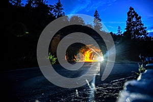 Lights of a Car leaving the Wawona Tunnel in the Evening - Yosemite National Park, California photo