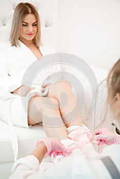 Wax bath for feet at beauty spa salon. Paraffin wax treatments for feet.