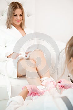 Wax bath for feet at beauty spa salon. Paraffin wax treatments for feet. photo