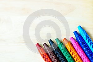 wax crayons on wooden background with copy space