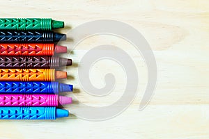 wax crayons on wooden background with copy space