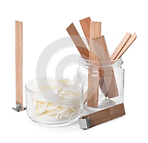 Wax flakes and wooden wicks on white background. Making homemade candle