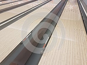 Waxed wooden bowling alley lanes with bumpers