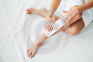 Waxing. Beautician Waxing Woman`s Leg In Spa Salon