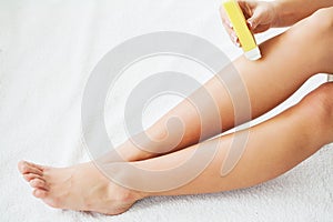 Waxing. Beautician Waxing Woman`s Leg In Spa Salon