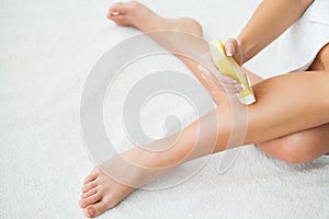 Waxing. Beautician Waxing Woman`s Leg In Spa Salon