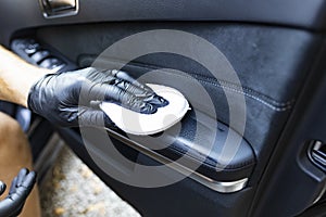 Waxing leather upholstery in the car door