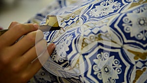 Waxing the patterns on the textile for batik