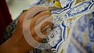 Waxing the patterns on the textile for batik
