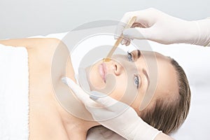 Waxing woman leg. Sugar hair removal. laser service epilation. Salon wax beautician procedure