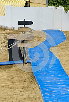 Way on the beach with several signposts