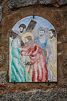 Way of the cross. 5th Station. Simon of Cyrene helps Jesus to carry the cross. Painted ceramic tile, Ingurtosu, Arbus, Sardinia