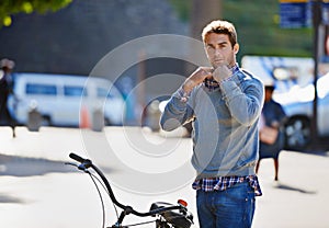 The only way I travel in the city. a handsome man about to take a ride on his bicycle in the city.