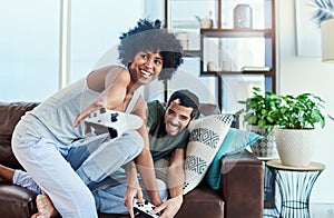 This is the only way Ill win. a young couple having fun while playing video games at home.