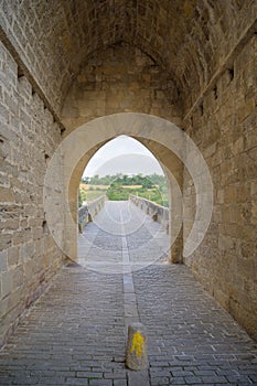 Way marking with yellow arrow symbol sign on St. James Pilgrimage route in Puente la Reina, Navarra