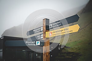 Way sign at Black Sand Beach Reynisfjara, Iceland during foggy weathe