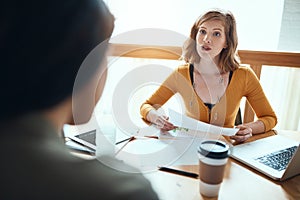 The only way to win is through teamwork. young businesspeople having a meeting in a modern office.