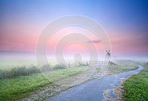 Way to windmill in morning fog