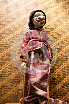 Wayang golek with batik background photo