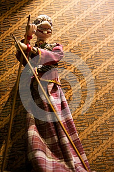 Wayang golek with batik background photo