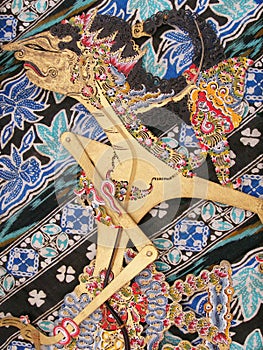 Wayang Kulit puppet on batik photo