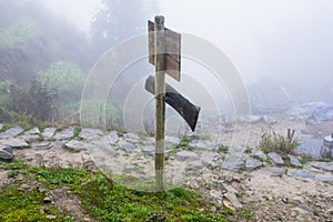 waymark on mountain path in misty spring day