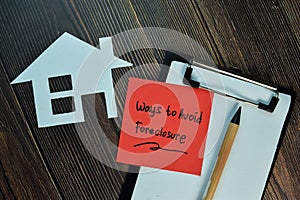 Ways to Avoid Foreclosure write on sticky notes isolated on Wooden Table
